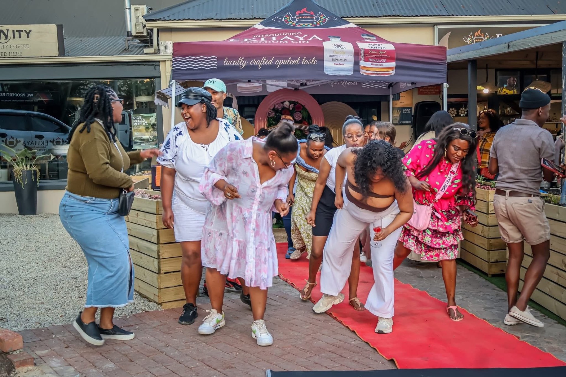 Guests dancing on the red carpet at the Ekhaya Gin launch