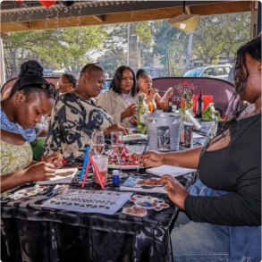 Friends painting together at an Ekhaya event